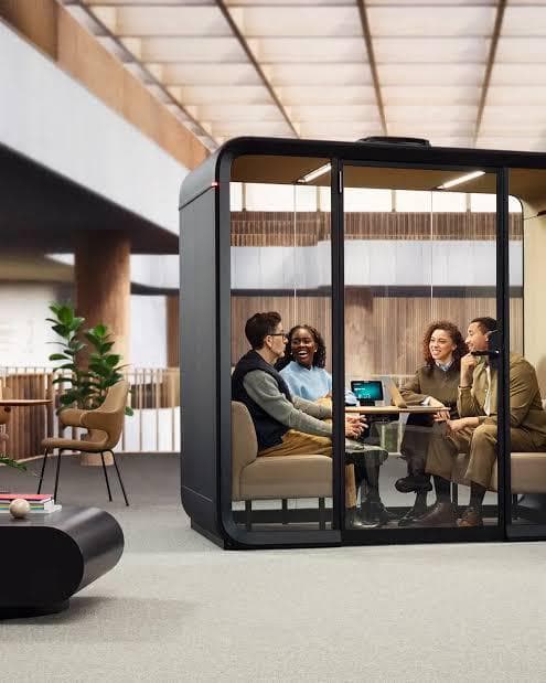 A SiloPod acoustic meeting pod with a team of four meeting inside